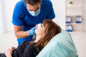 Young woman visiting doctor in plastic surgery concept