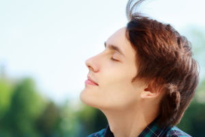 man breathing fresh air