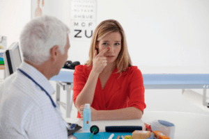 female patient explaining sinus issue to doctor