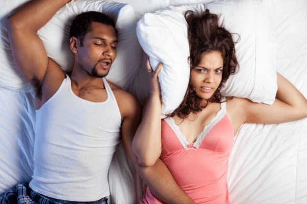 wife annoyed with husbands snoring